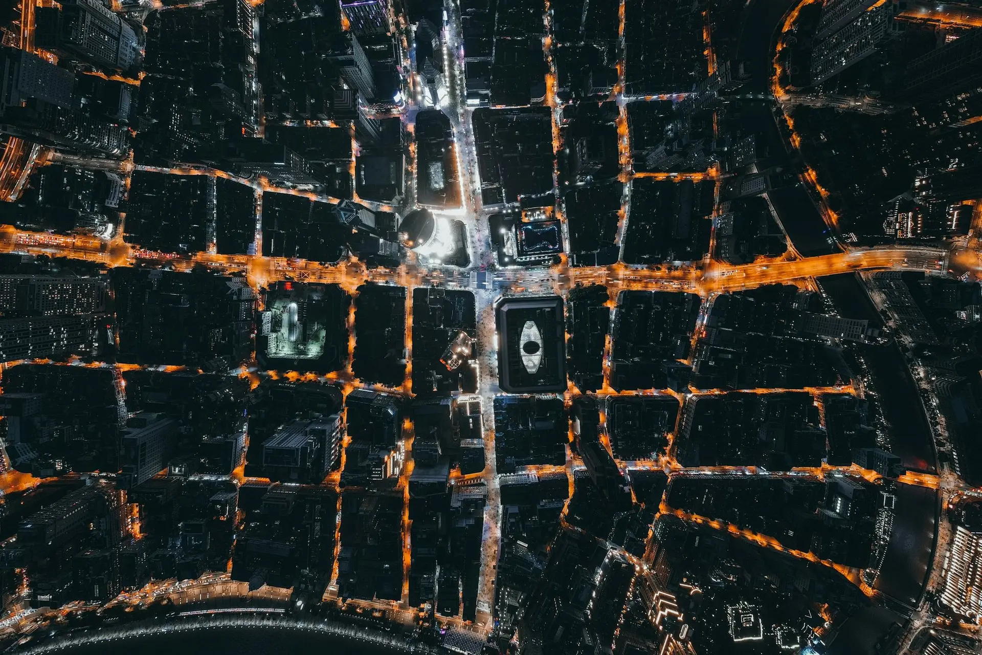 Aerial view of a city's lit street grid at night
