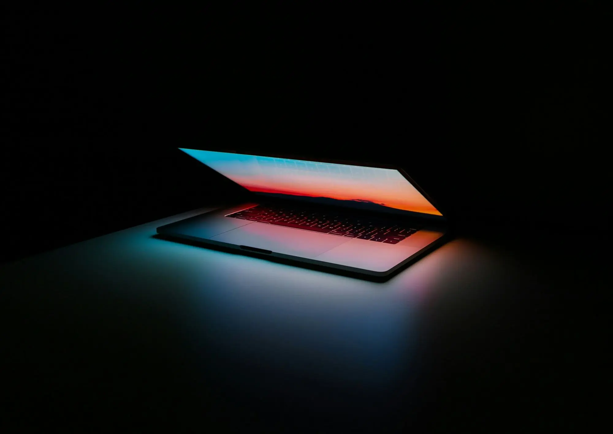 Laptop opening with light spilling from the screen