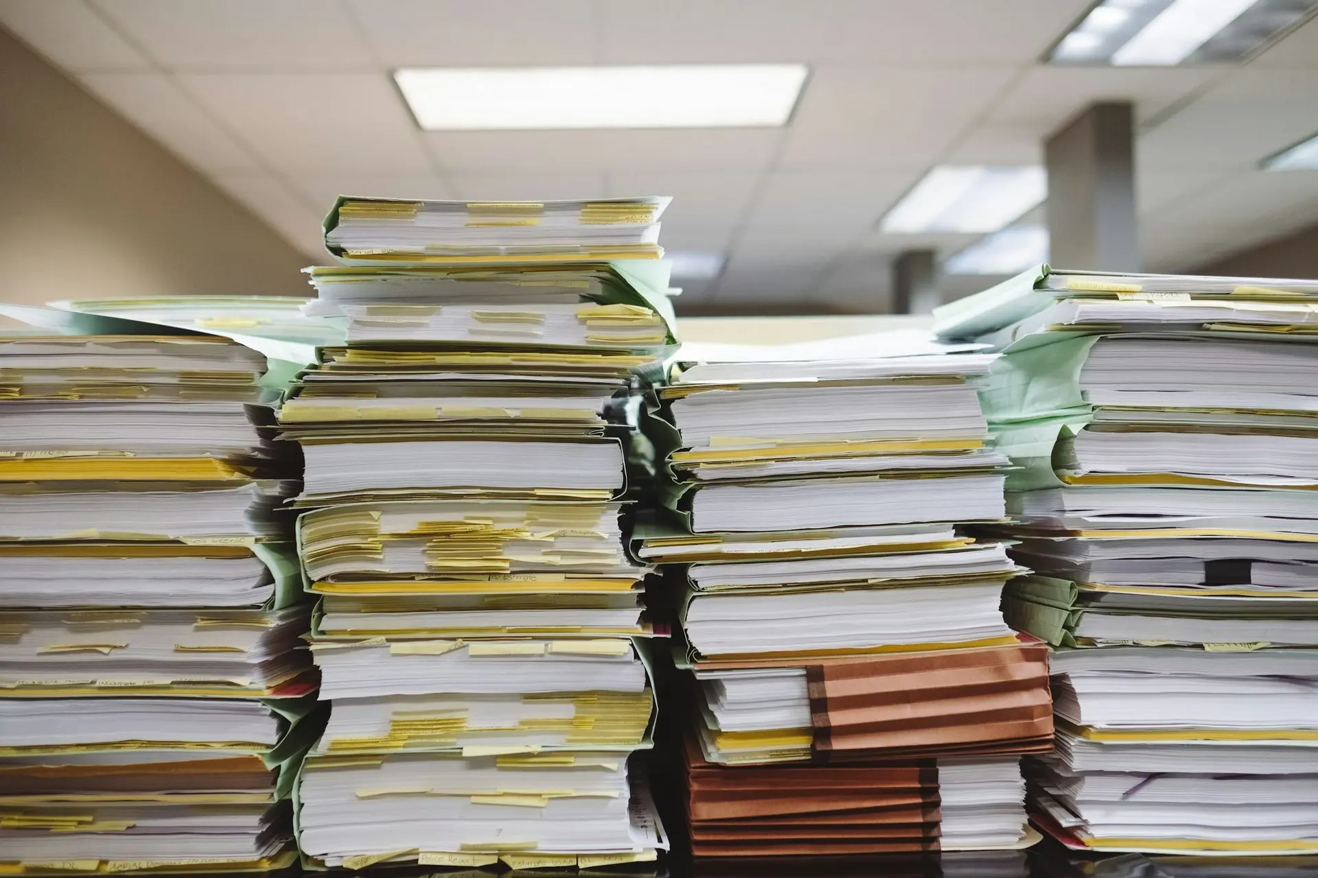 Tall stacks of paper files in an office